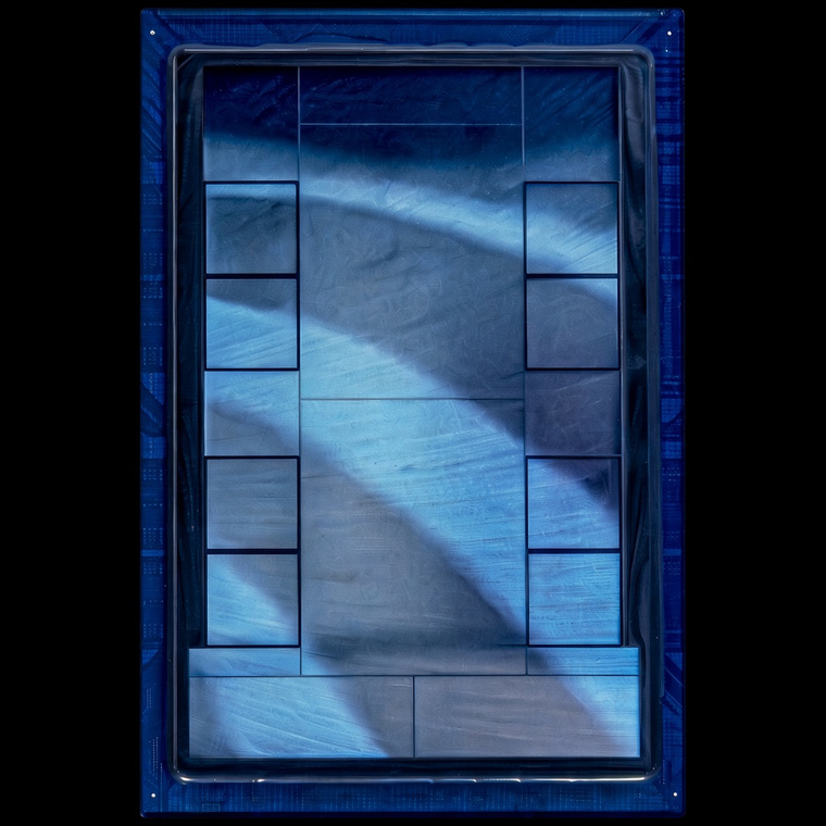 Meta MTIA chip package: blue-tinted silicon and memory stacks inside a blue frame, on a black background.